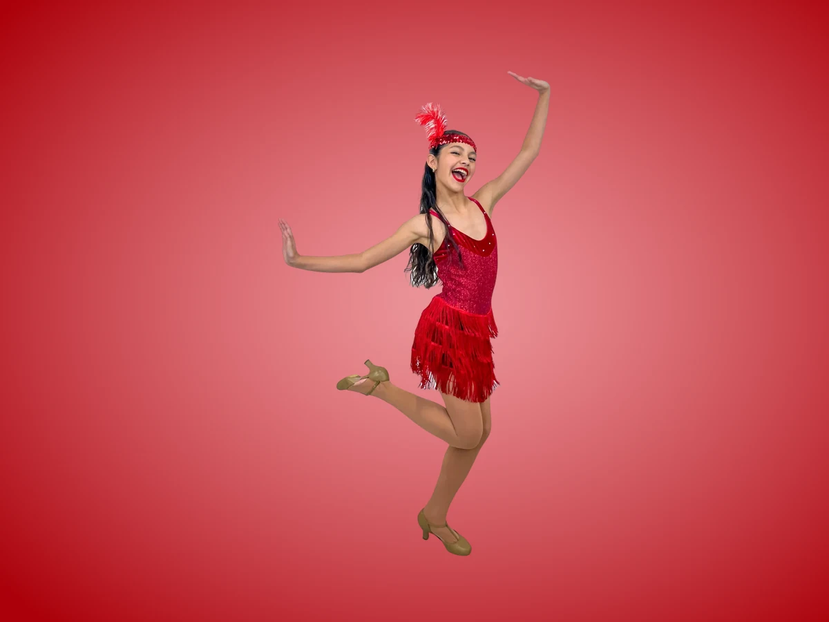 Adult dancer in a red fringe dress posing in tap heels