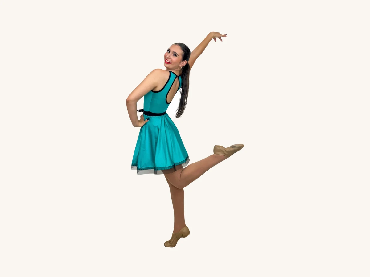 Adult dancer in a teal jazz dress mid-kick