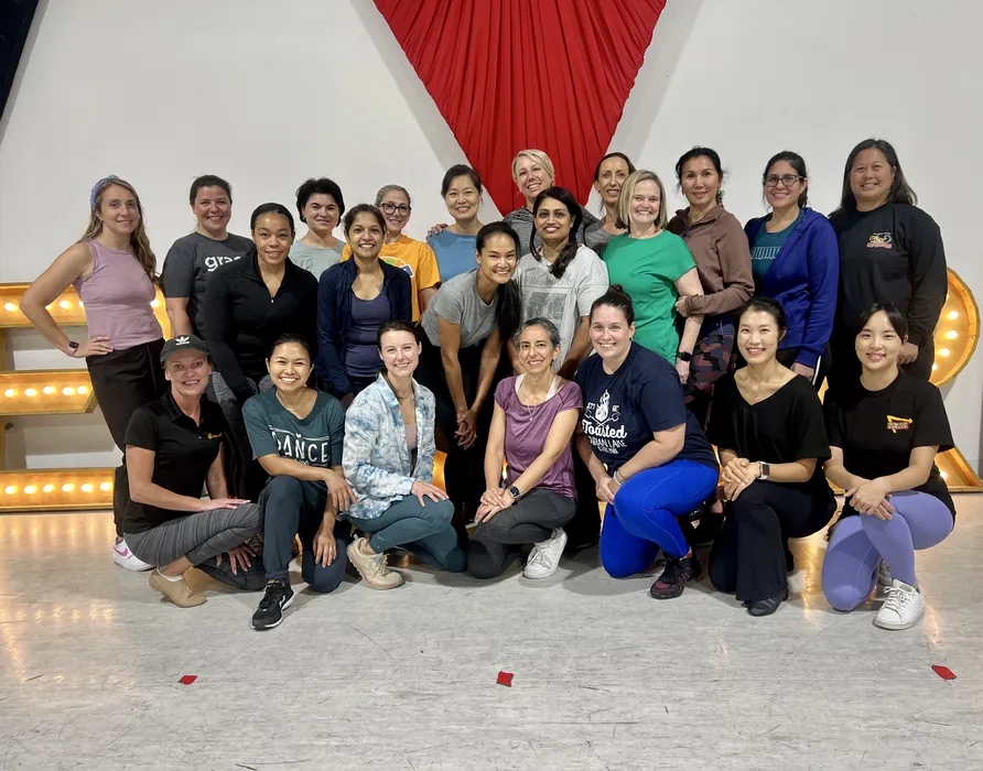 The adult session group gathered together in front of the studio backdrop