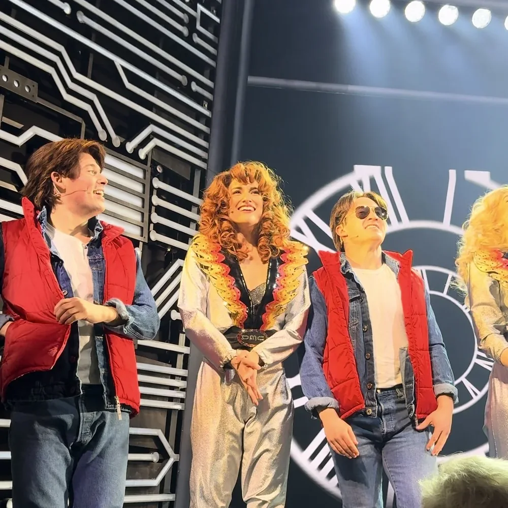 Jessie Peltier with the Back to the Future company at curtain call under the show's clock face set