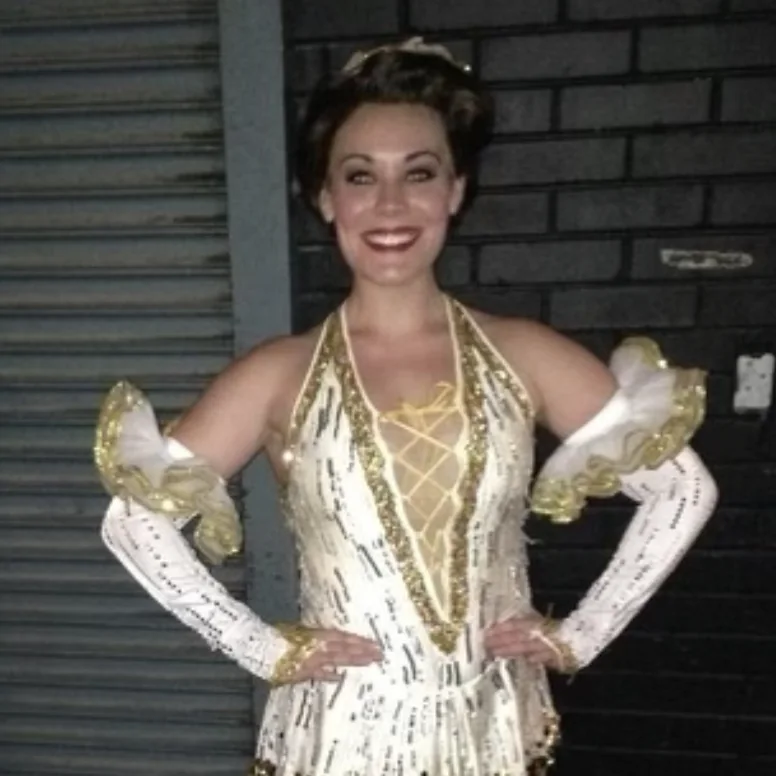 Courtney Moran in a gold and white sequinned costume on the 42nd Street national tour