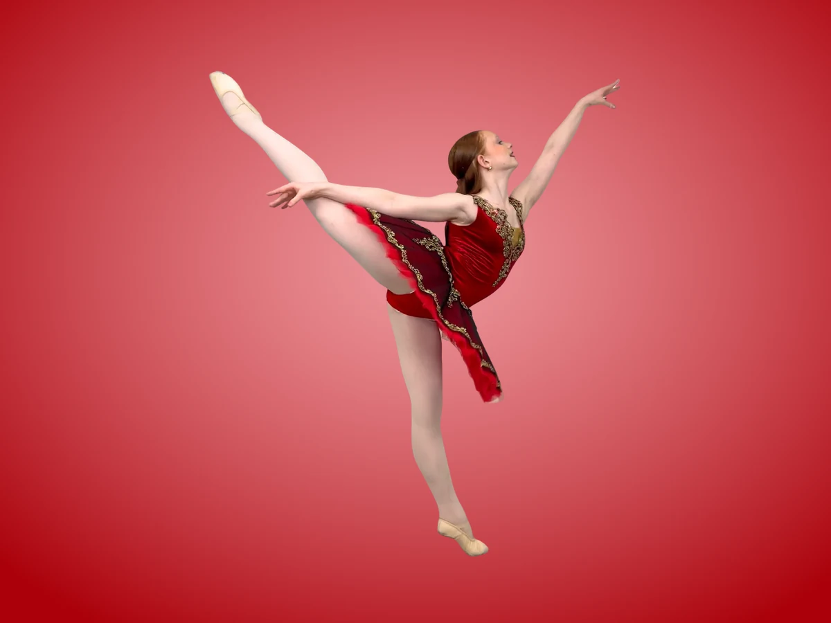 Encore dancer in a ballet costume posing on pointe