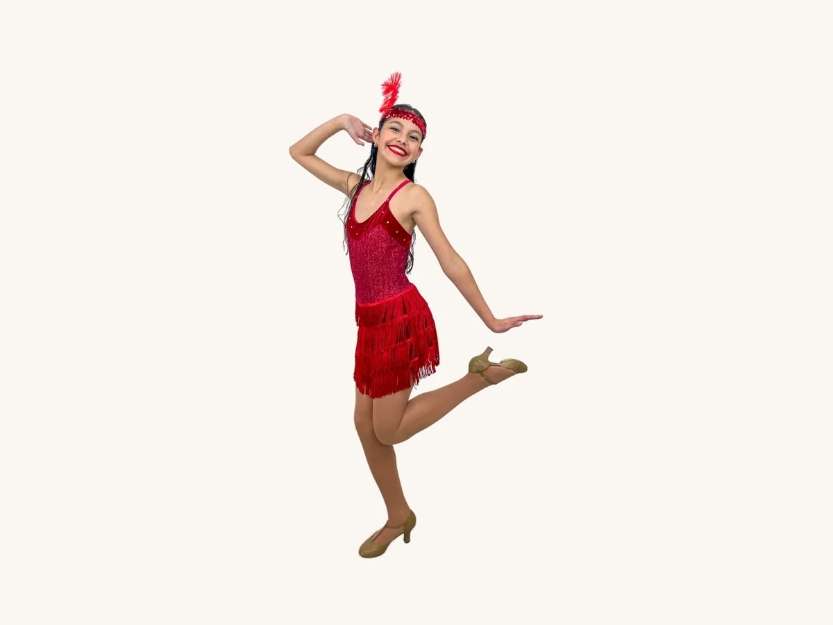 Encore dancer in a red fringe flapper dress posing mid-step