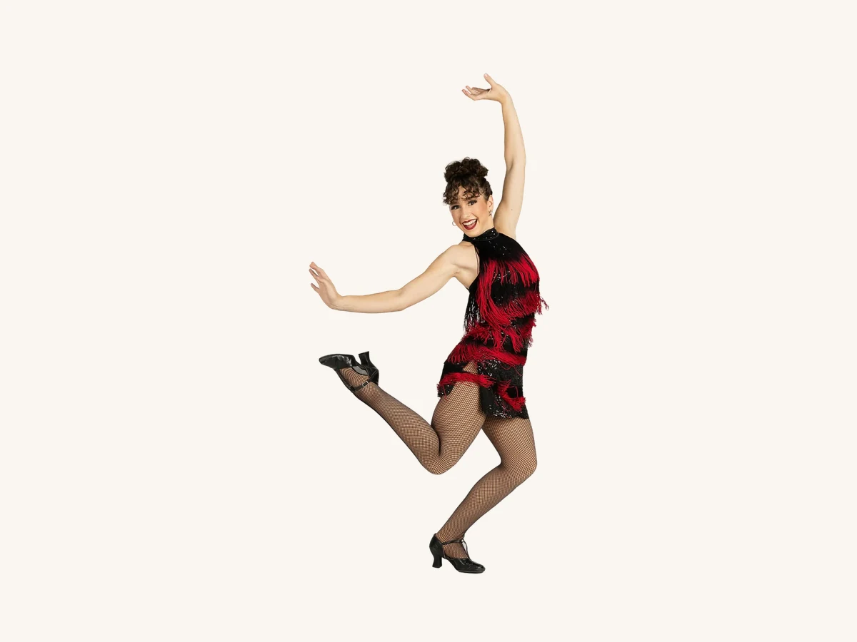 Encore dancer in a red and black fringe dress kicking up in tap shoes