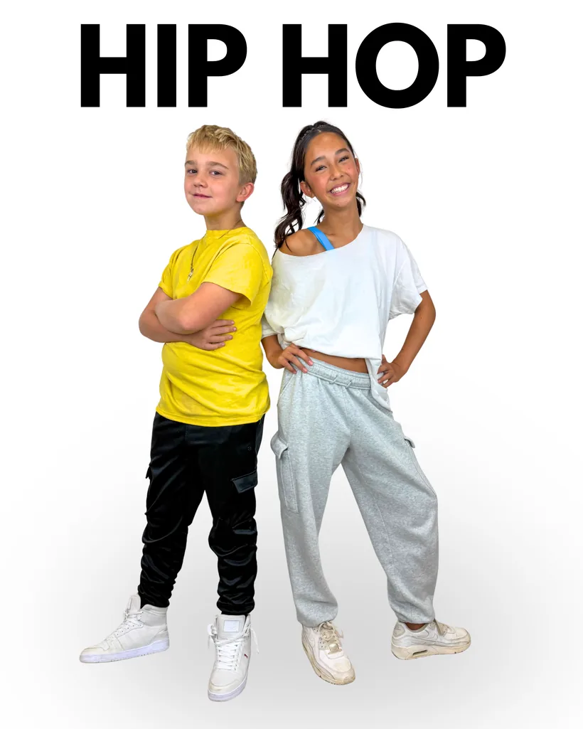 Hip-hop dress: a girl in a white top with loose grey joggers and white trainers, and a boy in a yellow t-shirt, black joggers and black trainers