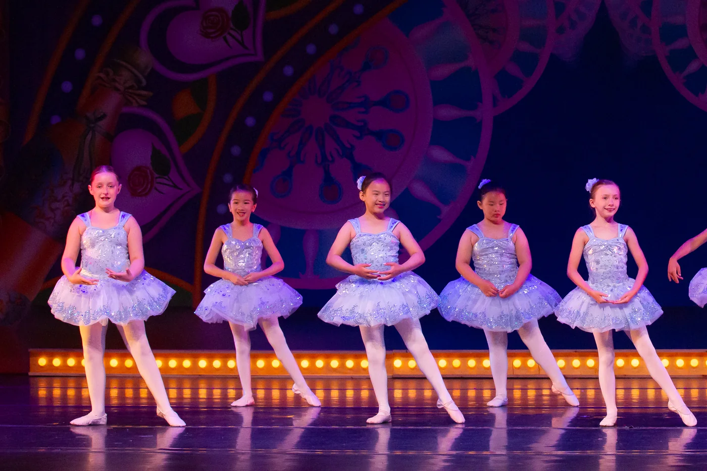 A line of Junior dancers in pale blue tutus across the stage