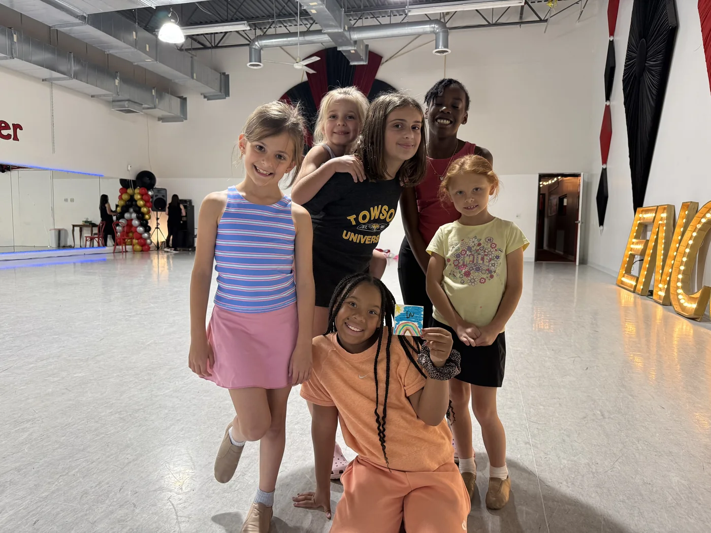 Campers cheering with their arms in the air in the studio