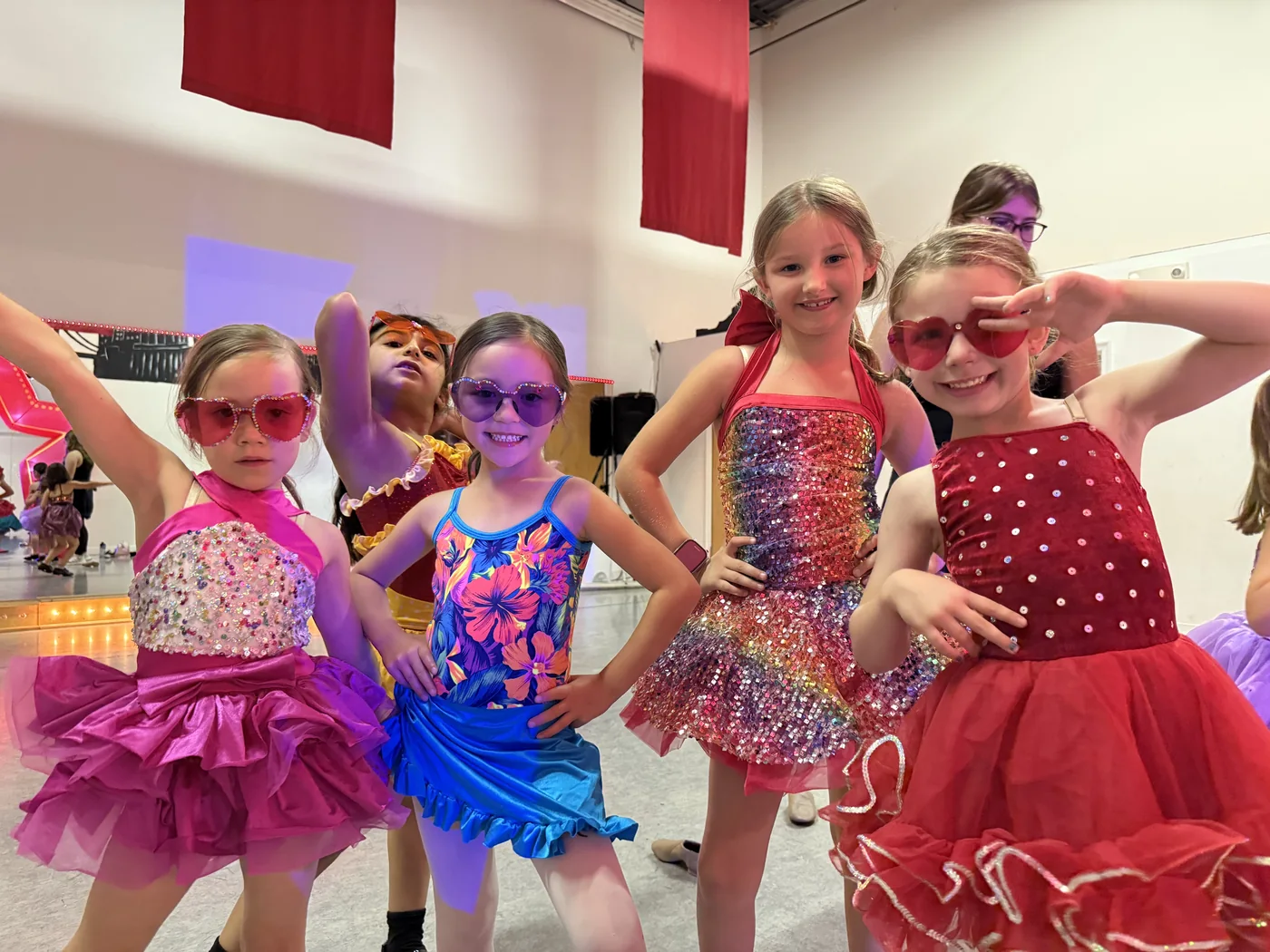 Campers in sparkly costumes and heart sunglasses posing together
